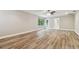 Large living room with wood-look floors and sliding glass doors at 17307 Linda Vista Cir, Lutz, FL 33548