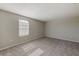 Simple bedroom with carpeted floor and large window at 11321 Alachua Creek Ln, Riverview, FL 33579