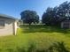 Expansive backyard with green grass and large trees, offering ample space at 6002 Christy Ln, Riverview, FL 33578