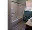 The bathroom showcases a tub with white tiling, a shower curtain rod, and a window at 6002 Christy Ln, Riverview, FL 33578