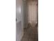 Long hallway featuring tiled flooring and several doorways at 6002 Christy Ln, Riverview, FL 33578