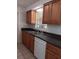 Kitchen with wood cabinets, a dark countertop, and tiled backsplash at 6002 Christy Ln, Riverview, FL 33578