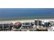 Stunning aerial view of beachfront condos along the sandy beach with the blue ocean in the background on a sunny day at 19440 Gulf Blvd # 201, Indian Shores, FL 33785