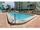 Inviting outdoor pool with lounge chairs, perfect for relaxation in a quiet, community setting at 19440 Gulf Blvd # 201, Indian Shores, FL 33785