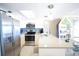 A well-lit kitchen that features stainless steel appliances and blue tile back splash at 19440 Gulf Blvd # 201, Indian Shores, FL 33785