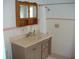 Bathroom with pink tile, vanity, and shower at 3247 Kimberly Oaks Dr, Holiday, FL 34691