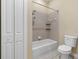 Bathroom with shower tub combo, toilet, and linen closet at 11516 Bellamar St, Temple Terrace, FL 33637