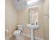 Small half bathroom with pedestal sink and toilet at 11516 Bellamar St, Temple Terrace, FL 33637