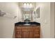 Vanity with dark countertop and wood cabinets at 11516 Bellamar St, Temple Terrace, FL 33637