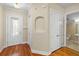 Townhouse entry with hardwood floors, coat closet, and half bath at 11516 Bellamar St, Temple Terrace, FL 33637