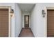 Front entry of townhouse with brown door and brick walkway at 11516 Bellamar St, Temple Terrace, FL 33637