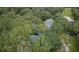 Aerial view of house nestled in lush green landscape at 5455 Lake Le Clare Rd, Lutz, FL 33558