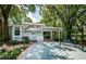 Backyard patio with a large concrete slab and shade trees at 5455 Lake Le Clare Rd, Lutz, FL 33558