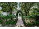 Landscaped backyard with brick walkway and arbor at 5455 Lake Le Clare Rd, Lutz, FL 33558