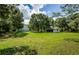 Large backyard with detached garage and lush trees at 5455 Lake Le Clare Rd, Lutz, FL 33558