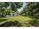 Spacious backyard with lush lawn and mature trees at 5455 Lake Le Clare Rd, Lutz, FL 33558