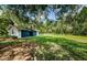 Detached garage with blue doors and large yard at 5455 Lake Le Clare Rd, Lutz, FL 33558