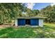 Detached garage with blue doors and large yard at 5455 Lake Le Clare Rd, Lutz, FL 33558