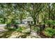 Relaxing pool area with a metal fence and lush landscaping at 5455 Lake Le Clare Rd, Lutz, FL 33558