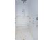 Large walk-in shower with multiple shower heads and marble bench at 5455 Lake Le Clare Rd, Lutz, FL 33558