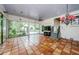 Sunroom with terracotta tile floor and sliding glass doors at 5455 Lake Le Clare Rd, Lutz, FL 33558