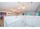 Simple white wet bar with sink and cabinets at 5455 Lake Le Clare Rd, Lutz, FL 33558