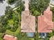 Aerial view of a home showing the pool, landscaping, and tile roof at 7656 Portstewart Dr, Lakewood Ranch, FL 34202