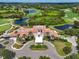 Aerial view of a clubhouse and golf course with surrounding ponds at 7656 Portstewart Dr, Lakewood Ranch, FL 34202