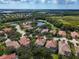 Beautiful aerial view of homes nestled among trees near a golf course and multiple ponds in a desirable community at 7656 Portstewart Dr, Lakewood Ranch, FL 34202