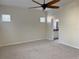 Bedroom leading to the ensuite bathroom and featuring neutral walls, carpet, and natural light at 7656 Portstewart Dr, Lakewood Ranch, FL 34202