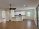 Open floor plan view of the kitchen with white cabinetry and breakfast bar at 7656 Portstewart Dr, Lakewood Ranch, FL 34202