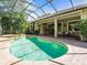 Enclosed pool with spa area surrounded by brick pavers and beautiful landscaping at 7656 Portstewart Dr, Lakewood Ranch, FL 34202