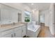 Elegant bathroom with soaking tub, dual sinks, and modern cabinets at 4638 Southern Valley Loop, Brooksville, FL 34601