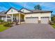 Two-story house with two car garage, front porch, and landscaped lawn at 4638 Southern Valley Loop, Brooksville, FL 34601