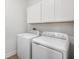 Bright laundry room featuring washer, dryer, and upper cabinets at 4638 Southern Valley Loop, Brooksville, FL 34601