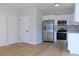 Bright kitchen featuring stainless steel appliances and white cabinetry at 1010 E Flora St, Tampa, FL 33604