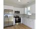 Modern kitchen with stainless steel appliances and white cabinets at 1010 E Flora St, Tampa, FL 33604