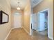 Bright entryway with tile flooring, mirror, and doors to other rooms at 10718 Standing Stone Dr, Wimauma, FL 33598