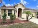 One-story house with red mulch and palm trees at 10718 Standing Stone Dr, Wimauma, FL 33598