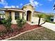 One story house with red mulch beds and landscaping at 10718 Standing Stone Dr, Wimauma, FL 33598