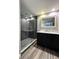 Bathroom features a vanity, large mirror and walk in shower at 2410 W Azeele St # 212, Tampa, FL 33609