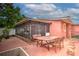 Backyard with screened patio, table and chairs, and shed at 6906 N Clark Ave, Tampa, FL 33614