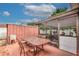 Backyard with patio, table and chairs, and screened enclosure at 6906 N Clark Ave, Tampa, FL 33614