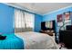 Blue bedroom with a queen-size bed and large flat-screen TV at 6906 N Clark Ave, Tampa, FL 33614