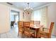 Bright dining room with chandelier and wooden table, chairs, and curtains at 6906 N Clark Ave, Tampa, FL 33614