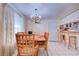 Dining area with wooden table and chairs, and a chandelier at 6906 N Clark Ave, Tampa, FL 33614