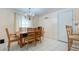 Simple dining room with wooden table and chairs near kitchen at 6906 N Clark Ave, Tampa, FL 33614