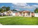 Cute pink house with white fence, landscaping, and driveway at 6906 N Clark Ave, Tampa, FL 33614