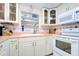 Cozy kitchen features white cabinets, pink countertops, and modern appliances at 6906 N Clark Ave, Tampa, FL 33614