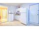 Small kitchenette with white cabinets and appliances at 6906 N Clark Ave, Tampa, FL 33614